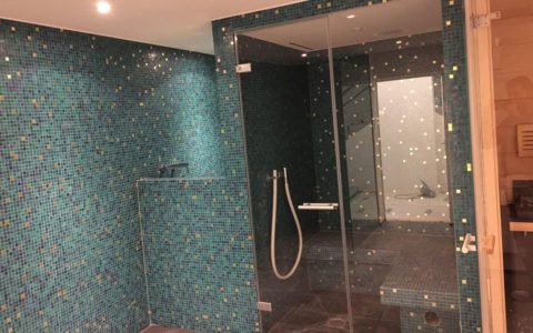 Badzimmer mit Mosaiksteinen und Duschkabine